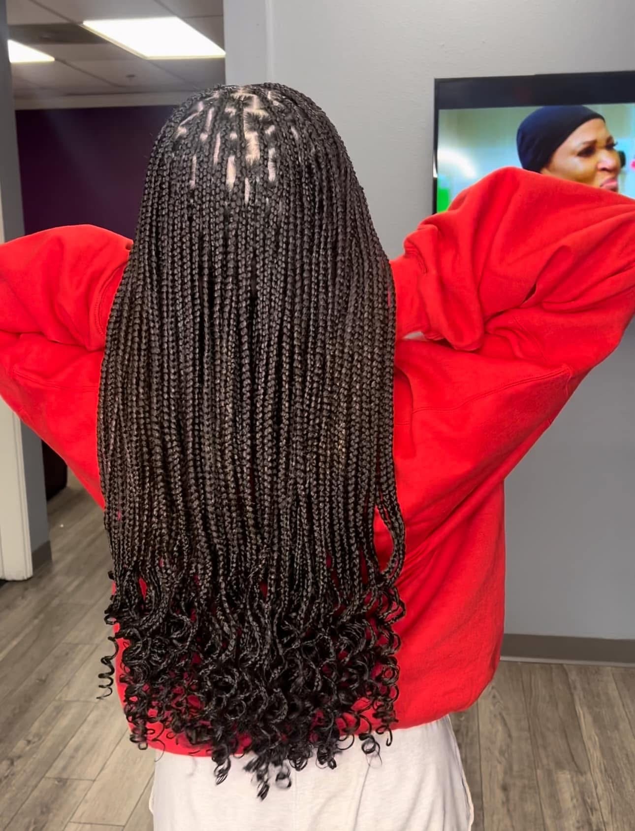 Long knotless braids with curly ends — back view